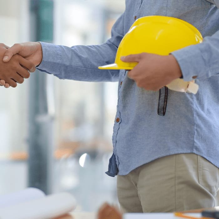 Client and consultant shaking hands on site