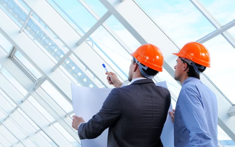 Consultants reviewing drawings on site as the owner's representative